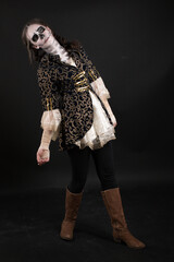Young teenage girl dressed up for halloween as pirate ghost, wearing a victorian overcoat and lace