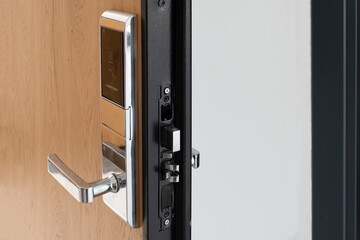 A modern exterior door decorated with wooden pattern and equipped with safe card lock system.