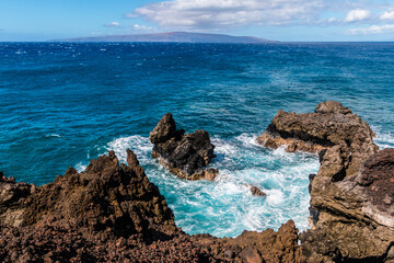 The Volcanic Shoreline of Cape Hanamanioa And Kaho'olawe Island Across The Blue Waters of La...