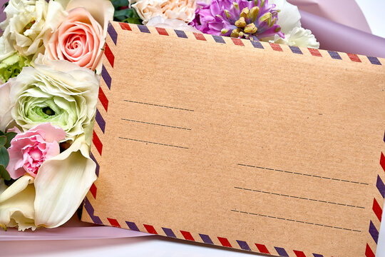 Postcard with a postal envelope and a bouquet of flowers for greeting. Concept Mother's Day