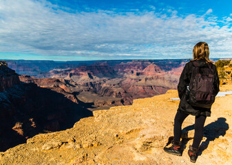 Female Hiker Admiring The Inner Canyon From The Rim Trail in Winter, South Rim, Grand Canyon National Park, Arizona, USA