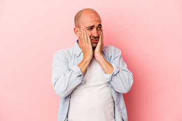 Young caucasian bald man isolated on pink background  scared and afraid.