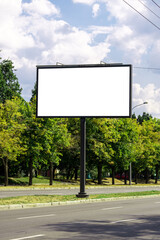 blank advertising billboard mockup. urban life. near park area. template for design. large advertising road banner