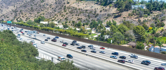 Automobiles, cars and trucks driving on 405 Freeway in Los Angeles California