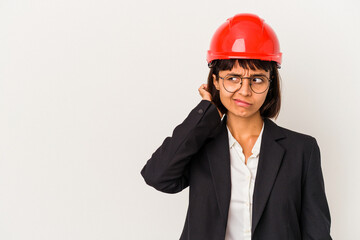 Young architect woman with red helmet isolated on white background touching back of head, thinking and making a choice.