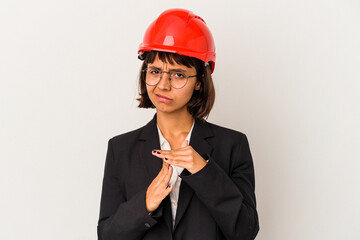 Young architect woman with red helmet isolated on white background showing a timeout gesture.