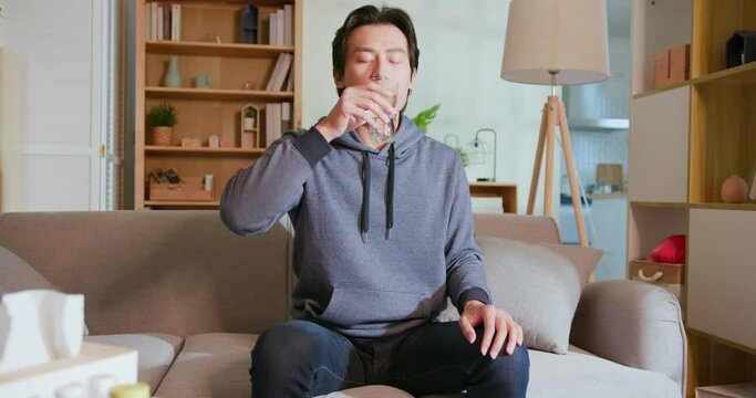 man takes medicine or vitamin