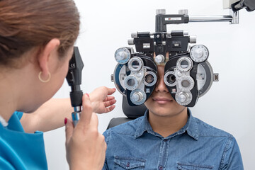 
Visual health problems of a Latino youth due to overexposure to computer screens and cell phones. An eye doctor examines the eyes