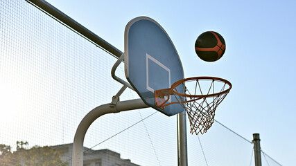On a 3-on-3 basketball court. The moment the ball is shot into the goal.