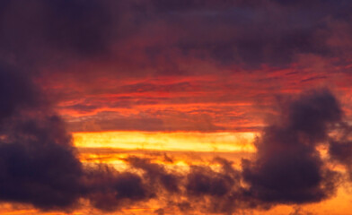 Bright sunset before the storm. Yellow and purple clouds at sunset, place for text, texture for background photo