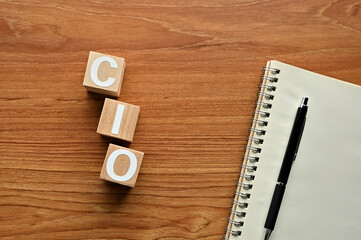 On a wood board, wooden word cubes are arranged in the letters CIO. It is an abbreviation for chief...