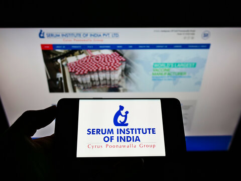 STUTTGART, GERMANY - Jun 02, 2021: Person Holding Smartphone With Logo Of Serum Institute Of India Pvt. Ltd. On Screen With Website.