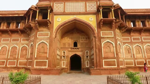 The Ancient Entrance of Jahangir Palace in Agra, India with Dolly Walking Toward Building.