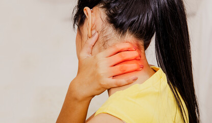Back view Woman pain in the back of the neck, degeneration of the neck, moving over the nerve. Or...