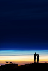 Silhouette of couple on sunset with copy space