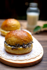 Delicious homemade chocolate bread on cutting board with a bottle of fresh milk as background