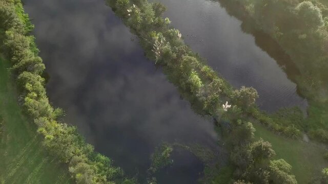 droneshot of the wetland blye sky the marsh divided into two lates.mp4