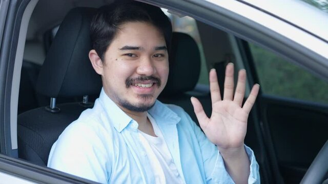 slow motion scene adult middle eastern man driver taxi looking outside and raiding hand for good emotion for service job concept
