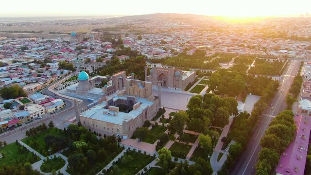 Madrasahs In Registan With City Views At Dusk In Samarkand, Uzbekistan. - aerial