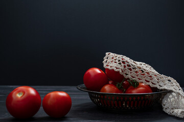 Tomatoes on black background