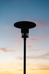 lamp post against sunset sky