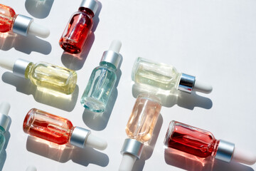 Dropper glass bottles with pipette. Transparent hyaluronic natural beauty mineral product and eco serum skin care concept. Top horizontal view copyspace. Summer juicy colors