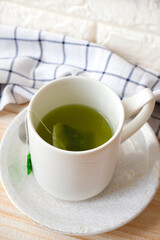Hot green tea with tea bag