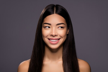 Fototapeta premium Photo of cheerful positive dreamy lady look side empty space toothy smile isolated grey color background