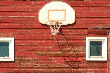 red barn with old basketball hoop © Tracy Grazley