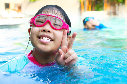 kids in goggles in swimming pool