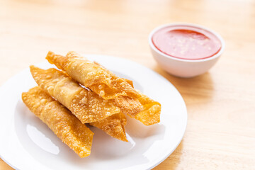 Fried pork wontons with  sauce.