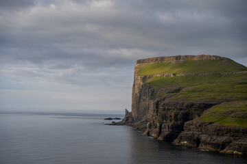Naklejka premium Beautiful aerial view of the Tjornuvik village in the middle of the Mountains in Faroe Island