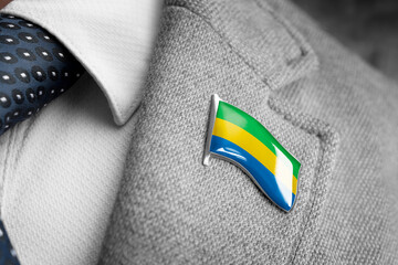 Metal badge with the flag of Gabon on a suit lapel