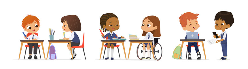 Cheerful diverse kids in school uniform talking sitting tables enjoying lesson inclusion education - 455412946