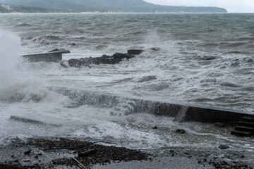 storm on the black sea, waves crashing on the shore, brown water