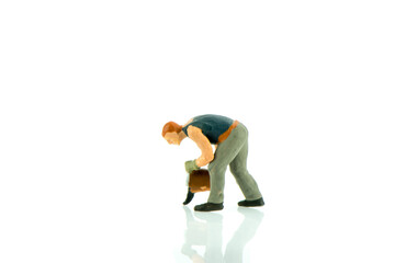Fototapeta premium Miniature people cleaning up concept on white background with a space for text