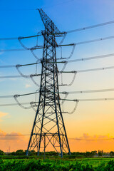 High voltage power tower industrial landscape at sunrise,urban power transmission lines.