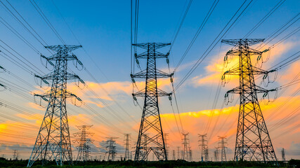 Fototapeta premium High voltage power tower industrial landscape at sunrise,urban power transmission lines.