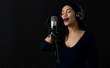 Happy Asain woman as professional singer catching earphone, smile, enjoy practicing attractive...