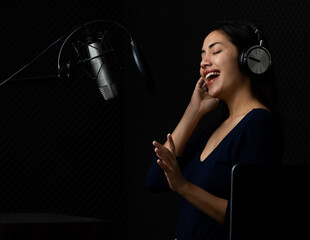 Beautiful Asian woman as elegant singer wearing acoustic headphone happy on pretty voice and enjoy...