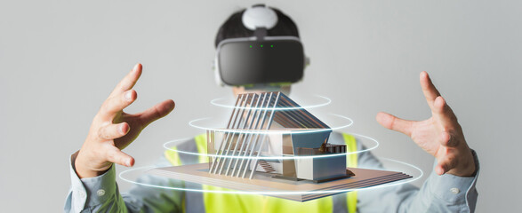 Architect or Engineer designer wearing VR headset for BIM technology working design 3D house model in building complete.