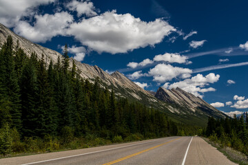 Road in a mountain valley. Canadian mountains, clouds.