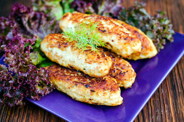 Chicken cutlets on a plate with lettuce