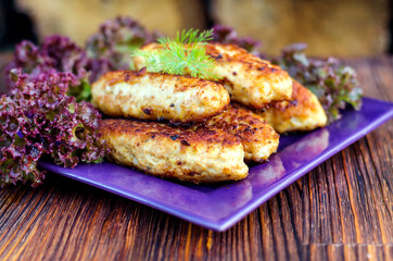 Chicken cutlets on a plate with lettuce