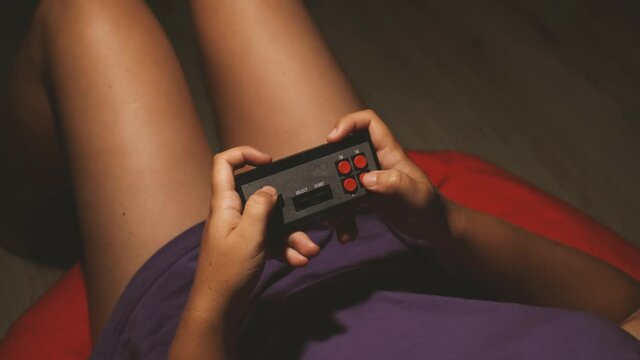 Close up top view of the obsolete joystick gamepad. A girl playing video game