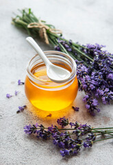 Fototapeta na wymiar Jar with honey and fresh lavender flowers