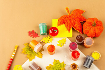 Obraz na płótnie Canvas Creative autumn colors composition. Gouache, brushes, paper, traditional decor
