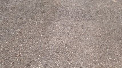 Crack on gray asphalt texture background. Road construction and design concept. Worn out bad asphalt