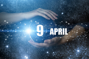 April 9th. Day 9 of month, Calendar date. Human holding in hands earth globe planet with calendar...