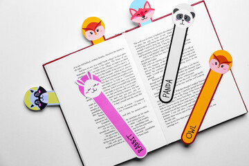 Cute bookmarks with book on light background